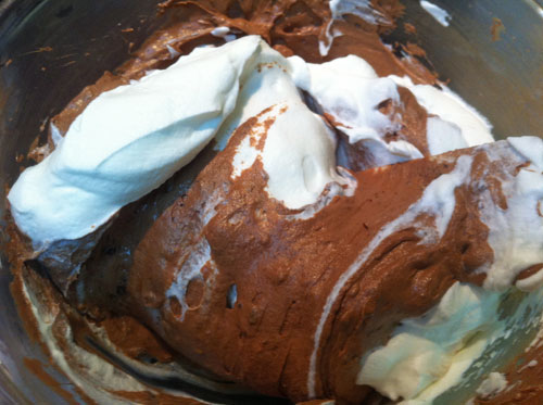 Whipping cream being folded into the pie filling.